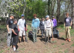 Ken Sammond and a small group of community volunteers stand proudly at the trail head to the Peter J. Barnes Wildlife Preserve