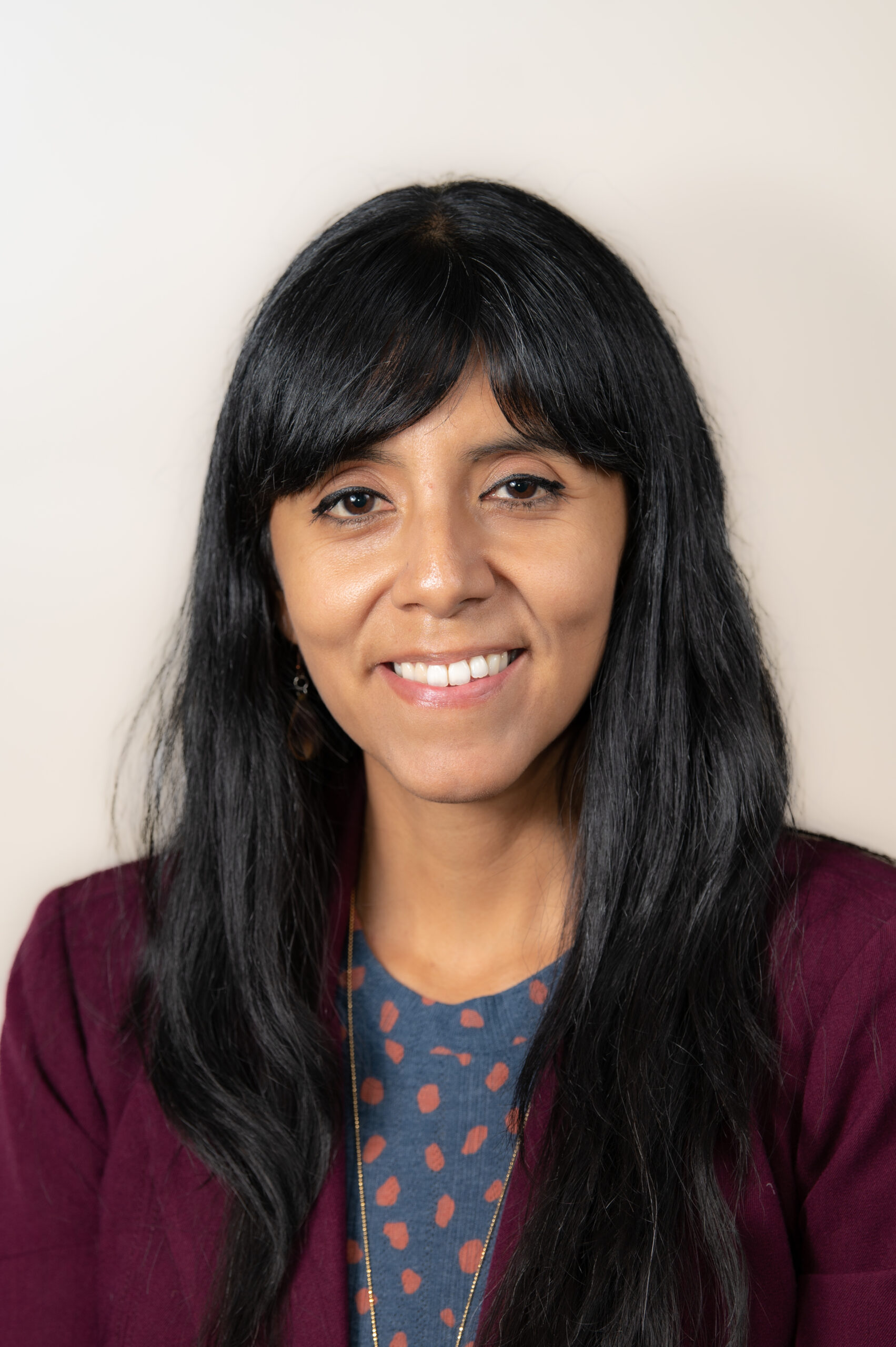 An image of a woman with long straight black hair.