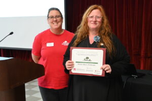 Two people posing with a certificate